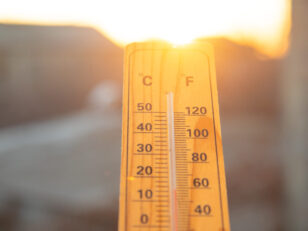 Thermometer on sky background. Sunset. Weather